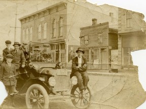 The Strathroy Library circa 1913 in the Odd Fellows Hall on Front Street East. The 1913 fire insurance map indicates that the east two-thirds of this building is the Library. The west third is a “Cobbler”.  The young man with folded arms on the front of the car is Russ Statham.  Source: Bill Groot.