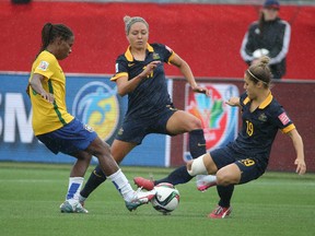 Australia forward Kyah Simon, No. 17, and midfielder Katrina Gorry, No. 19, play for the ball against Brazil midfielder Formiga during the second half of Sunday's game in Moncton. (USA TODAY SPORT)
