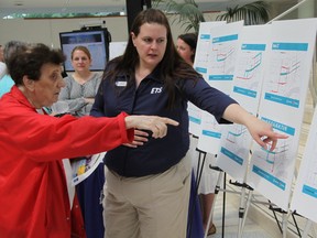 ETS employee Candace Lozinski, helps bus rider Isla Dotto learn more about some of the route changes coming to the city's downtown as a result of the new Valley Line LRT at an open house at City Hall on Tuesday (DAVE LAZZARINO/EDMONTON SUN)