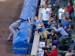 A fan attending the Cubs game caught a foul ball while feeding his baby on Tuesday. (MLB.com)