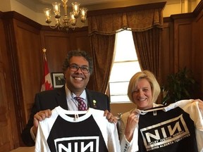 Calgary Mayor Naheed Nenshi and Premier Rachel Notley show off their matching NIN shirts in a photo tweeted by Nenshi's chief of staff on Tuesday, June 24, 2015. The shirt borrows the logo from the band Nine Inch Nails, but in their case stands for Notley, (Edmonton mayor Don) Iveson and Nenshi. Beneath the logo it says "Building Alberta Together." (Twitter/@chimaincalgary)