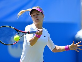 Canada's Eugenie Bouchard returns against Switzerland's Belinda Bencic during their women's singles third round match at the WTA Eastbourne International tennis tournament in Eastbourne, southern England on June 24, 2015. Bouchard retired in the second set. AFP PHOTO / GLYN KIRK