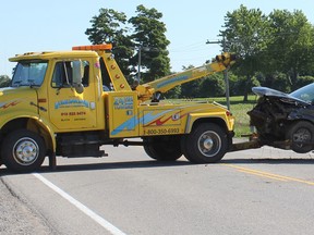 A tow trucks pulls away the suspected van involved in an early morning collision on June 24 near Londesborough. (Laura Broadley/Clinton News-Record)