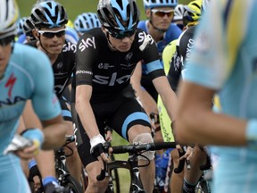 Britain's Christopher Froome injured rides in the pack after a fall during the 163.5 km fourth stage of the 101st edition of the Tour de France cycling race on July 8, 2014 between Le Touquet-Paris-Plage and Lille, nothern France.  AFP PHOTO / JEFF PACHOUD
