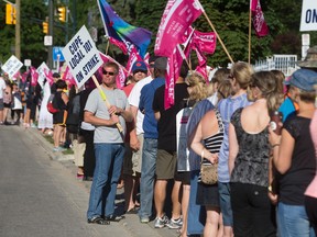 CUPE Local 101 strikers line up and face city hall as they picket outside 300 Dufferin Avenue in London, Ont. on Wednesday June 24, 2015. (CRAIG GLOVER, The London Free Press)