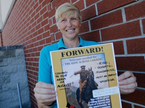 Emily Mountney-Lessard/The Intelligencer
Georgie Jones, who spent 31 years in the RCAF, holds a poster advertising the Communities for Veterans Foundation horseback ride across Canada on Wednesday in Belleville. Ride organizers are seeking participants and supporters.