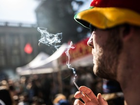 A person smokes a pot joint during the 420 protest against prohibition and the celebration of marijuana in Vancouver, B.C. on Monday April 20, 2015. Just two months later, despite warnings from the federal government, the city has approved new regulations for medical marijuana stores. Carmine Marinelli/Postmedia Network