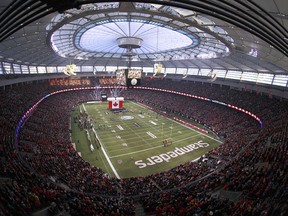 Fans look on during the Canadian national anthem at the start of the 102nd Grey Cup Championship Game between the Hamilton Tiger-Cats and the Calgary Stampeders at BC Place November 30, 2014 in Vancouver, British Columbia, Canada. Calgary won 20-16. Jeff Vinnick/Getty Images/AFP