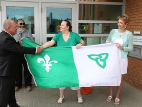 Greater Sudbury Mayor Brian Bigger, Joanne Gervais, middle, executive director of ACFO, and Nickel Belt MPP France Gelinas display a Franco-Ontarian flag at Saint-Jean-Baptiste Day celebrations at the Dowling Leisure Centre  in Dowling, Ont. on Wednesday June 24, 2015. The festivities included a Franco-Ontarian flag-raising ceremony, cake and refreshments and musical performances from students at Ecole St-Etienne. John Lappa/Sudbury Star/Postmedia Network