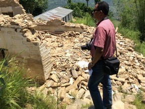 Jyoti Vaidya examines a collapsed school building on a recent trip to Nepal.
