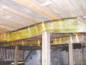 The main support beam of this deck is warped and appears to have a large crack. Proper construction of decks is essential because a collapse could result in injuries.