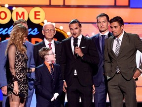 Erik Karlsson of the Ottawa Senators speaks to Jonathan Pitre during the 2015 NHL Awards at MGM Grand Garden Arena on June 24, 2015, in Las Vegas. Also on stage are Amy Purdy, Daniel Alfredsson, Bryan Murray, Mark Stone and Cody Ceci.  Ethan Miller/Getty Images/AFP