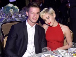 Recording artist Miley Cyrus (R) and Patrick Schwarzenegger attend the Pre-GRAMMY Gala and Salute to Industry Icons honoring Martin Bandier at The Beverly Hilton Hotel on February 7, 2015 in Los Angeles, California.  Larry Busacca/Getty Images/AFP