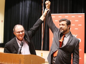Nickel Belt MP Claude Gravelle holds Paul Loewenberg's hand up in victory after he defeated Stephanie Harris at the Sudbury NDP nomination meeting Wednesday. Gino Donato/Sudbury Star