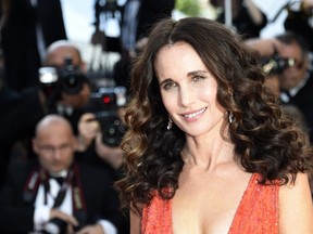 US actress Andie MacDowell poses as she arrives for the screening of the film "Inside Out" at the 68th Cannes Film Festival in Cannes, southeastern France, on May 18, 2015.    AFP PHOTO / LOIC VENANCE
