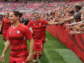 Canada’s Christine Sinclair interacts with fans as the team enters the pitch during a Women's World Cup soccer game against Switzerland in Vancouver on June 21, 2015. (Carmine Marinelli/Postmedia Network)