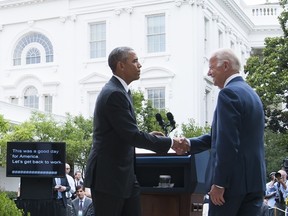 U.S. President Barack Obama shakes hands with Vice President Joe Biden after speaking about the Supreme Court's ruling to uphold the subsidies that comprise the Affordable Care Act, known as Obamacare, in the Rose Garden of the White House in Washington, DC, June 25, 2015. AFP/Saul Loeb