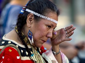 Residential school survivor Patricia Tucknaow wipes away a tear while walking to honour residential school survivors in Vancouver, June 11, 2015. (BEN NELMS/Reuters)