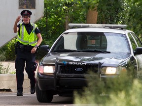 Edmonton police cordon off an area of Kinsmen Park as they search for a reported black bear sighted near Emily Murphy Park in Edmonton, Alta., on Thursday June 25, 2015. Ian Kucerak/Edmonton Sun/Postmedia Network