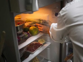 Man reaching into refrigerator. A fridge, like this one, was emitting an awful stench so putrid that it sent eleven people to hospital. 

REUTERS/Marco Bello