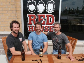 Brothers, Dan, left to right, Dave and Mike Reid, owners of the Red House, sit outside the new location they are in the process of opening in the city's west end. (Julia McKay/The Whig-Standard)