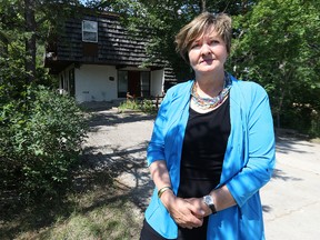 City councillor Janice Lukes stands in front of a property on Thatcher Drive off University Crescent in Winnipeg believed to house as many as 15 students on Thu., June 25, 2015.