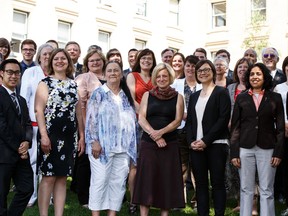 NDP MLAs and Premier Rachel Notley (centre) pose for an Edmonton International Folk Festival ad photo on the south lawn of the Alberta Legislature in Edmonton, Alta., on Thursday June 25, 2015. Ian Kucerak/Edmonton Sun/Postmedia Network