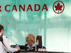 A man checks into an Air Canada flight at the Toronto Pearson International Airport in Toronto, Sept. 20, 2011.    REUTERS/Mark Blinch