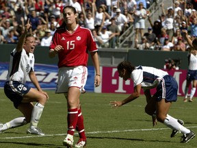 Kara Lang (15) of Canada walks away as Abby Wambach (left) and Shannon Boxx of the U.S. celebrate during their third-place match at the 2003 Women’s World Cup in Carson, Calif., October 11, 2003. (Postmedia Network file photo)