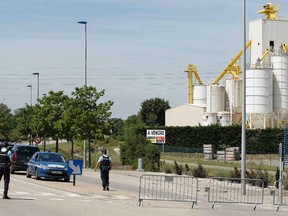 French Gendarmes block the access road to the industrial area of Saint-Quentin-Fallavier, outside Lyon, France, June 26, 2015. A decapitated head covered in Arabic writing was found at a a site belonged to Air Products, a U.S.-based industrial gases technology company, in southeast France on Friday, police sources and French media said, after two assailants rammed a car into the premises, exploding gas containers.  REUTERS/Emmanuel Foudrot