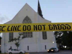 Police tape is seen near the Emanuel African Methodist Episcopal Church before it is opened for a Sunday service after a mass shooting at the church killed nine peopleon June 21, 2015 in Charleston, South Carolina. Suspect Dylann Roof, 21, was arrested and charged in the killing of nine people during a prayer meeting in the church, one of the nation's oldest black churches in the South, which is due to reopen to worshippers today.  Joe Raedle/Getty Images/AFP