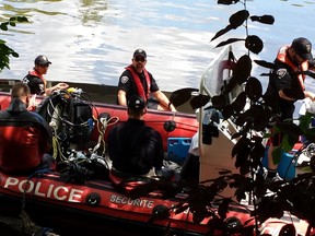 Ottawa police dive teams search the Rideau River Friday for a suspect who is feared to have drowned earlier in the week. (COREY LAROCQUE Ottawa Sun)