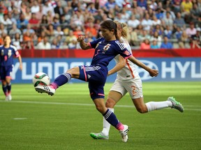 Japan defender Aya Sameshima (5) controls the ball against Netherlands defender Desiree Van Lunteren (2) during the first half in the round of sixteen in the FIFA 2015 women's World Cup soccer tournament at BC Place Stadium. (Matt Kryger-USA TODAY Sports)