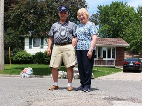 Joseph Theriault and his wife Mary show off the condition of Echo Road on Friday June 26, 2015 in Sarnia, Ont. The couple, who have lived on the north-end street for 36 years, have filed a petition with city hall to lobby for repairs to the heavily potholed road. Barbara Simpson/Sarnia Observer/Postmedia Network