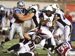 Ottawa Redblacks' Chevon Walker holds on to the ball as they drive against the Montreal Alouettes during second half CFL football action in Montreal, June 25, 2015. (REUTERS/Christinne Muschi)