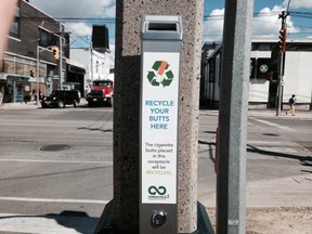 New cigarette receptacles are being mounted around a downtown-area intersection. (KEVIN CONNOR, Toronto Sun)