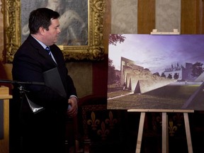 A controversial monument to victims of communism on Ottawa's main ceremonial street will now be significantly smaller, according to new plans for the site. Defence Minister Jason Kenney examines an artist's rendition of the National Memorial to Victims of Communism which will be situated near the Supreme Court of Canada in Ottawa on December 11, 2014.
THE CANADIAN PRESS/HO