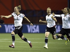 Germany's defender Leonie Maier, midfielder Simone Laudehr, midfielder Melanie Behringer and defender Babett Peter react after winning the quarter-final football match between Germany and France in the Women's World Cup at Olympic Stadium in Montreal on June 26, 2015. (AFP PHOTO/FRANCK FIFE)