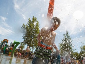 Nathan Cardinal, 2, plays in the splash park on a hot day at Jackie Parker Recreation Park in Edmonton, Alta., on Friday June 26, 2015. Alberta Health Services has warned about plus-30 degress Celcius days over the next four days. Ian Kucerak/Edmonton Sun