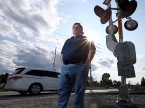 Frank Brydon stands near the train tracks on Greenbank Road on Friday June 26, 2015. Brydon wants Via trains to continue blowing their whistles when crossing the road on Greenbank Road. 
Tony Caldwell/Ottawa Sun