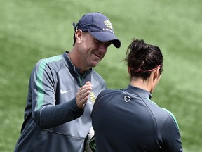 Australia's head coach Alen Stajcic (L) speaks with a player during a training session at the Moncton Stadium, New Brunswick on June 20, 2015, on the eve of Australia's 2015 FIFA Women's World Cup football match against Brazil.  AFP PHOTO/ FRANCK FIFE