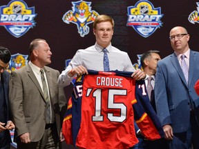 Lawson Crouse is presented with his team jersey after being selected as the number eleven overall pick to the Florida Panthers in the first round of the 2015 NHL Draft at BB&T Center. Mandatory Credit: Steve Mitchell-USA TODAY Sports