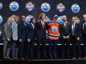 Connor McDavid poses on stage with Oilers ownership and management at the NHL Entry Draft in Sunrise, Florida on Friday. (USA TODAY SPORTS)