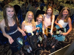 Emma Lavin, sisters Vienna, Prophecy, and Trinity Christiansen, and Stella Lavin helped collect over $1,800 cash at the Racing for a Cure Gala held last weekend in support of Kids With Cancer and the Autism Society.