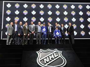 Mitch Marner is joined on the podium by members of the Maple Leafs executive after being selected No. 4 last night.(USA TODAY SPORTS)