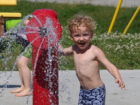 Jude Haapamaki, 3, cools off at the Kinsmen Sports Complex splash pad in Lively, Ont. on Friday June 26, 2015. John Lappa/Sudbury Star/Postmedia Network