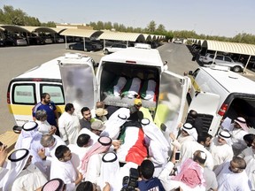 Bodies of victims of the Friday bombing are transferred to vehicles to be transported to Karbala, Iraq, at Al Jafariya cemetery in Suleibikhat, Kuwait June 27, 2015. REUTERS/Jassim Mohammed