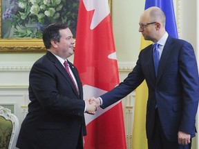 Ukraine's Prime Minister Arseny Yatseniuk (R) shakes hands with Canada's Defence Minister Jason Kenney during a meeting in Kiev, Ukraine, June 26, 2015. REUTERS/Andrew Kravchenko/Pool