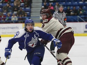 Kyle Capobianco, left, of the Sudbury Wolves, attempts to get past Steven Varga, of the Peterborough Petes, during OHL action in Sudbury this past season. John Lappa/Sudbury Star/Postmedia Network