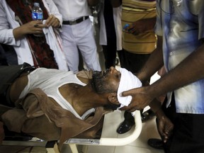 A local television cameraman Imran Shaikh, who collapsed due to an intense heat wave, has water-soaked towel placed on his forehead at an emergency ward in Jinnah Postgraduate Medical Centre in Karachi, Pakistan, June 27, 2015. (AKHTAR SOOMRO/Reuters)